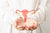 a doctor cups hands holding illustration of female reproductive system