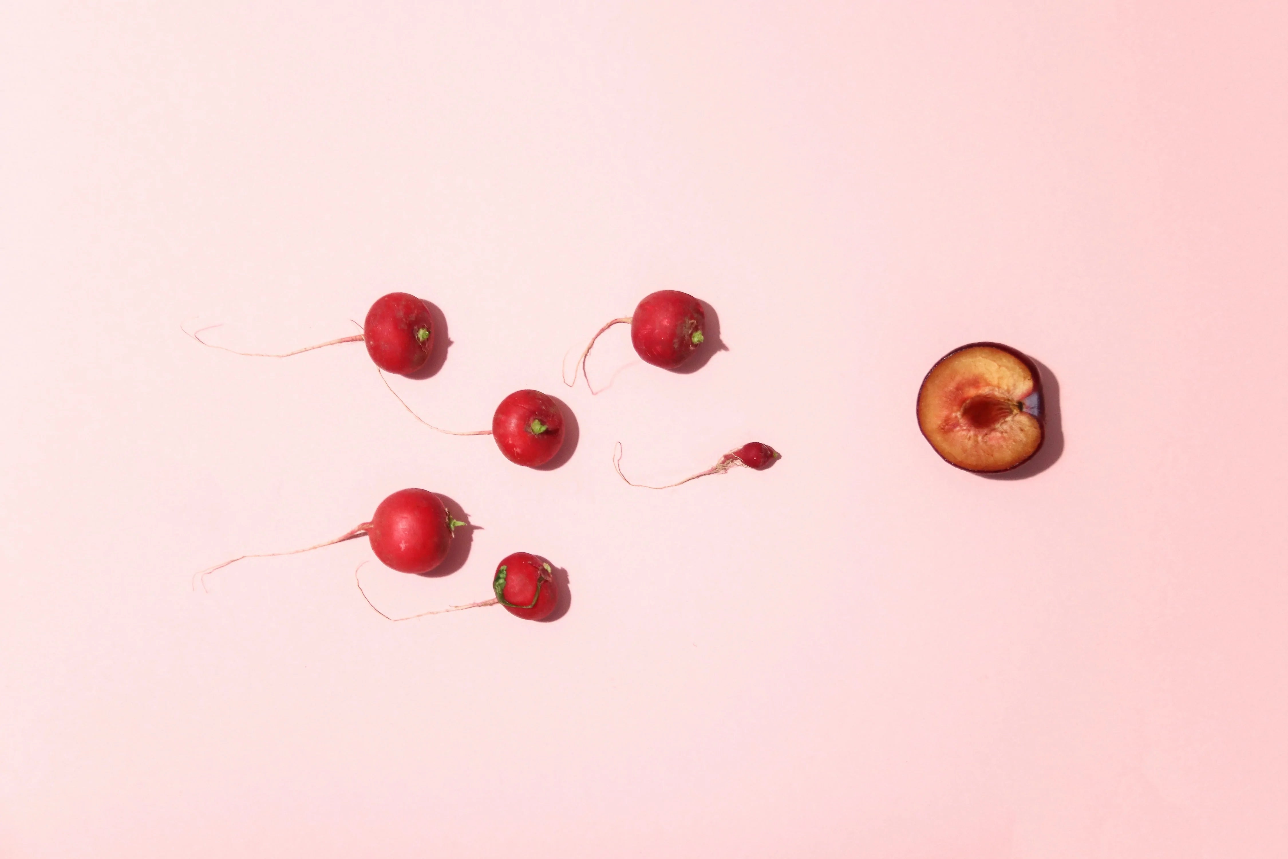 small radishes angled towards a cross-section of a peach