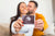 happy interracial couple shows off ultrasound baby scan